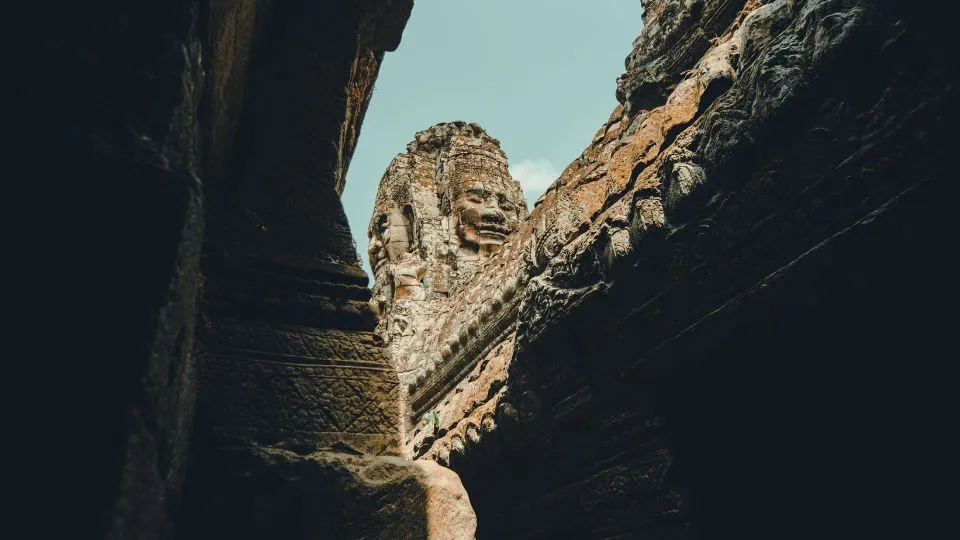 Carved stone face at an Angkor temple, seen from below