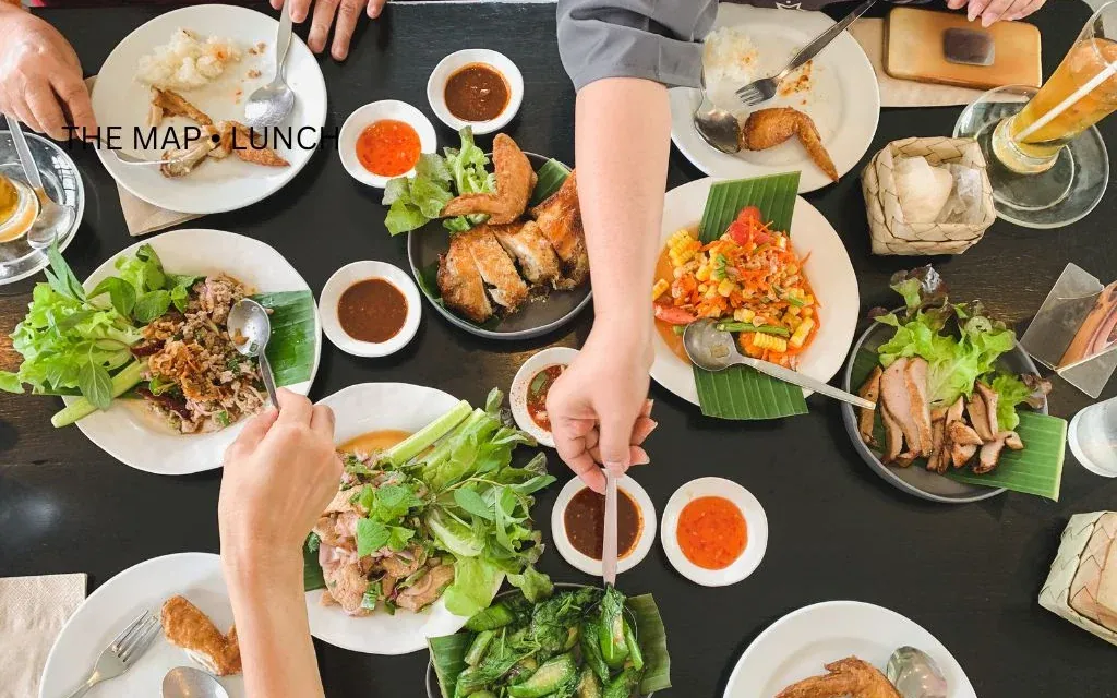 Illustrative photograph of a shared lunch table; no restaurant in the guide is depicted